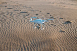 flying-drone-landing-sand-beach
