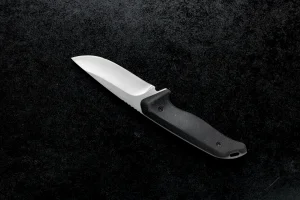 closeup-shot-small-combat-knife-with-black-handle-table