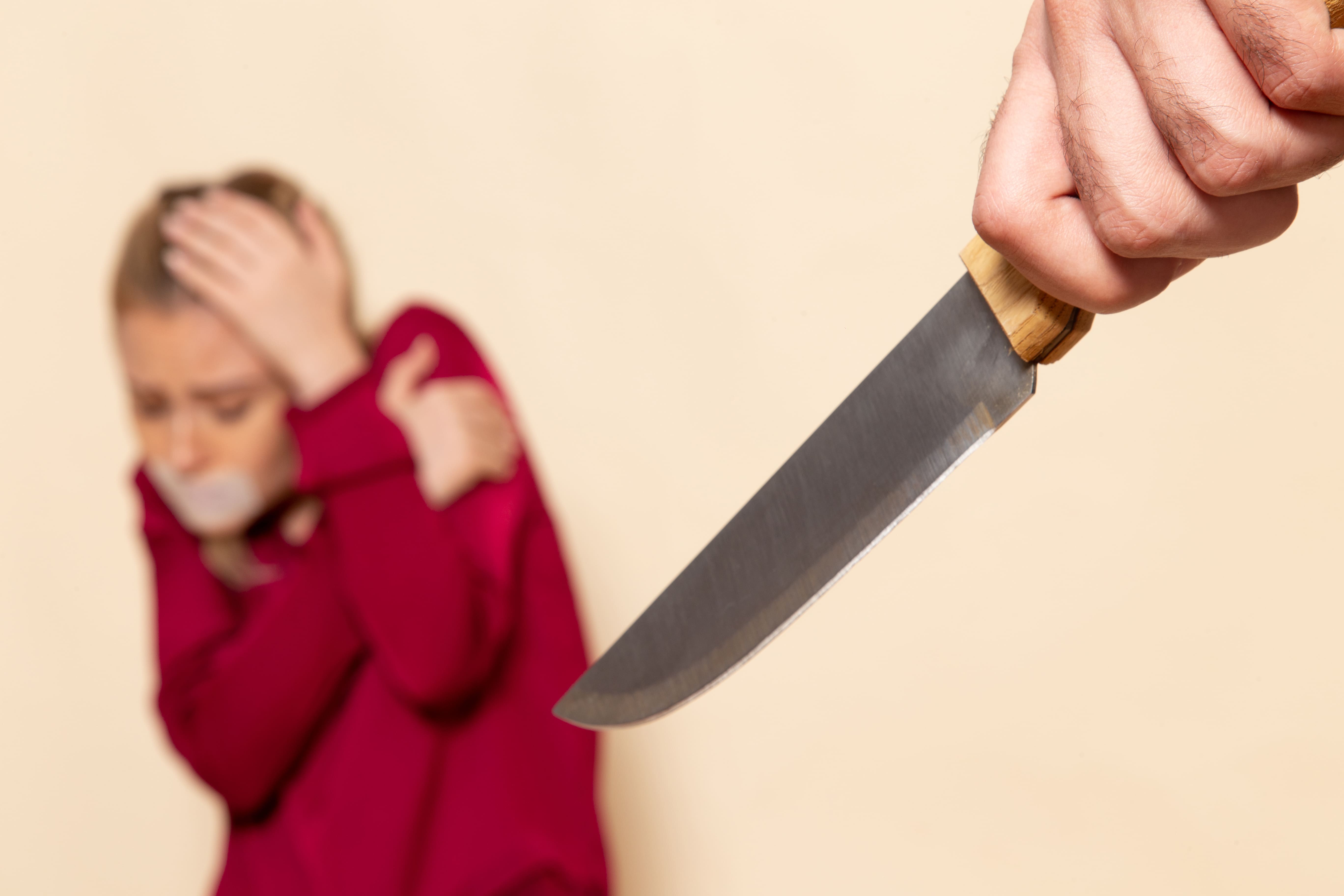 front-view-young-female-red-shirt-with-tied-mouth-scared-knife-cream-space-female-cloth-photo