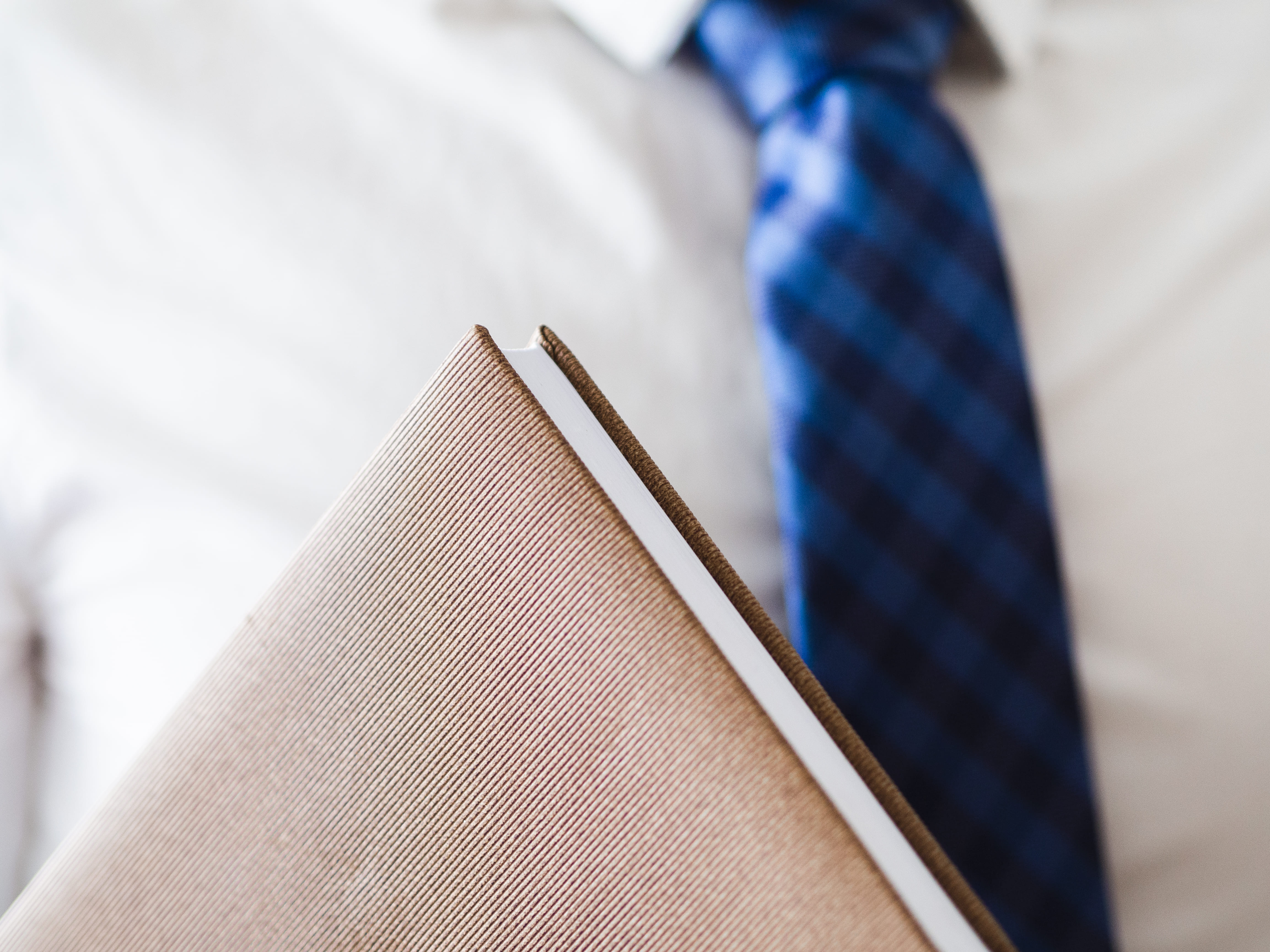 close-up-man-holding-leather-notebook (1)