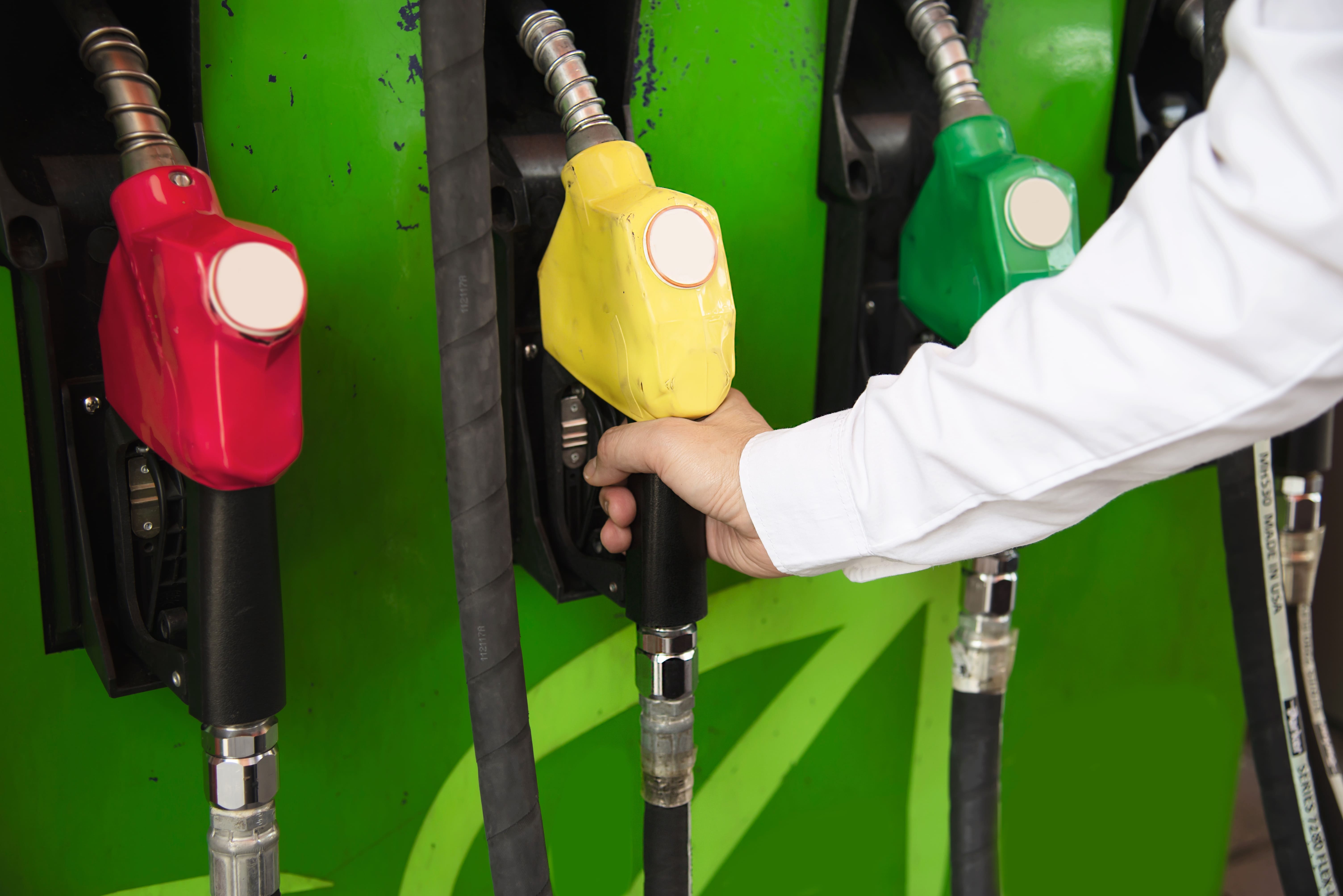 man-putting-gasoline-fuel-into-his-car-pump-gas-station