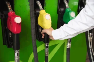 man-putting-gasoline-fuel-into-his-car-pump-gas-station