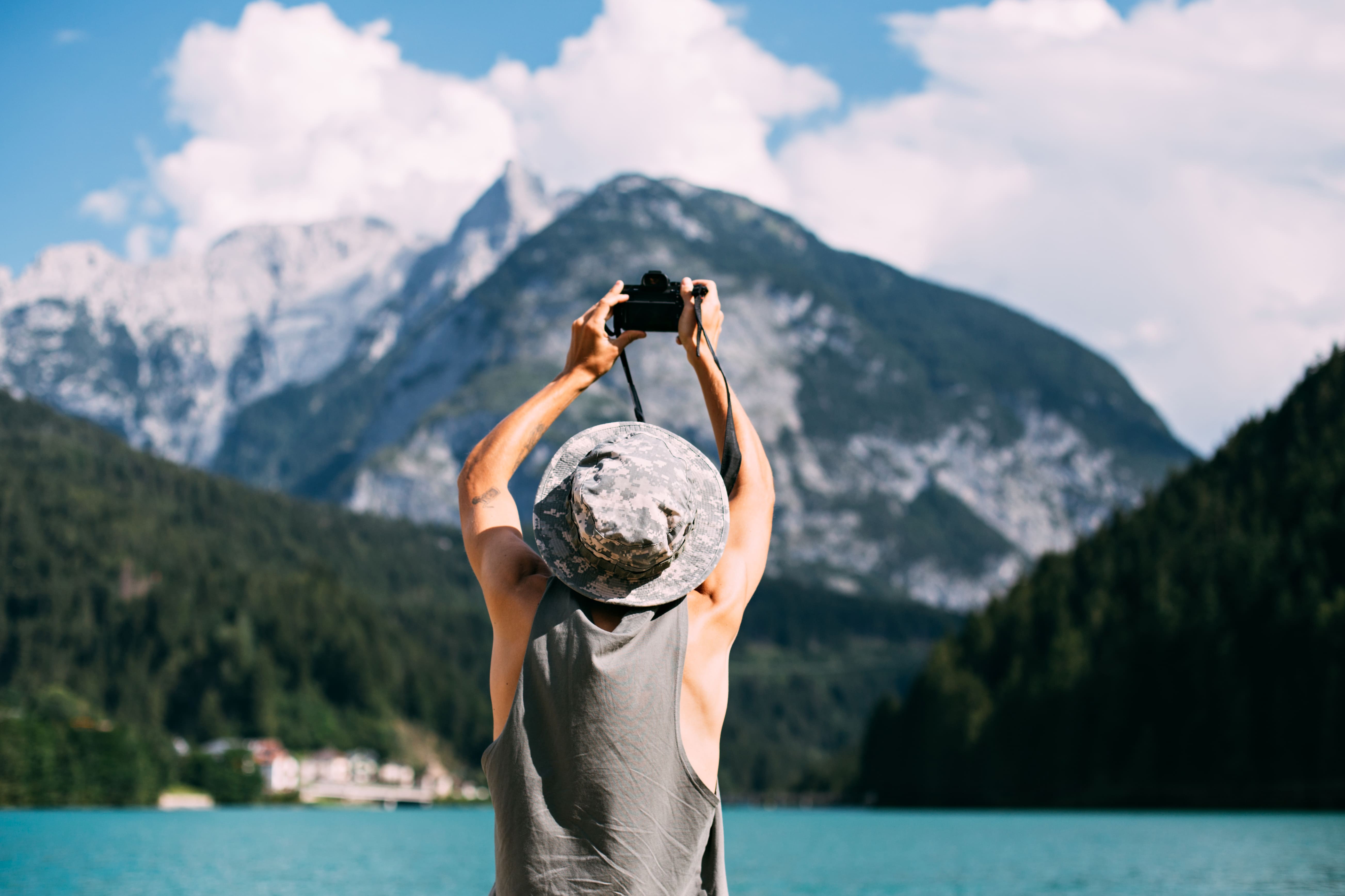 tourist-taking-photos-nature-landscape-using-his-smartphone